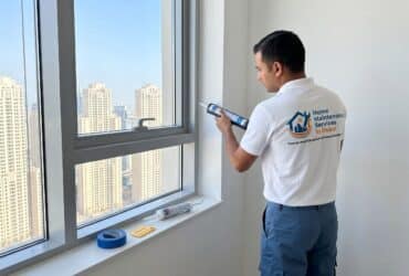 BHMS handyman applying silicone sealant How to reseal a window in a Dubai apartment