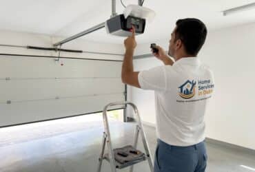 BHMS handyman programming a garage door opener remote in a Dubai villa garage