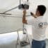 BHMS handyman programming a garage door opener remote in a Dubai villa garage